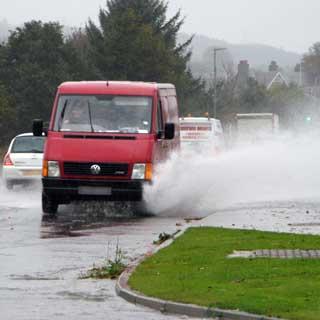 Photo of a van driving through floodwater
