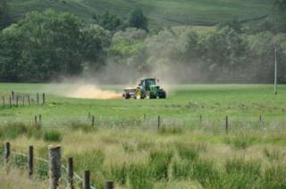 Tractor spraying fields